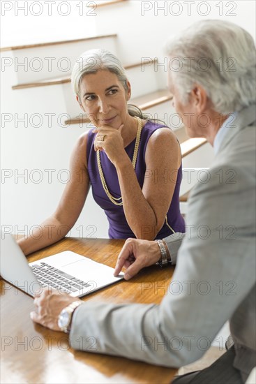 Caucasian couple using laptop