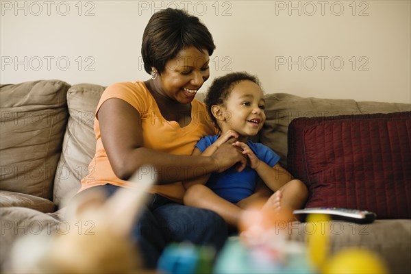 African mother playing with young son