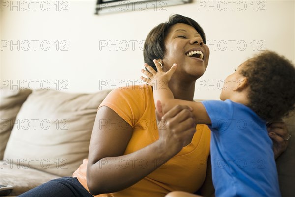 African mother playing with young son