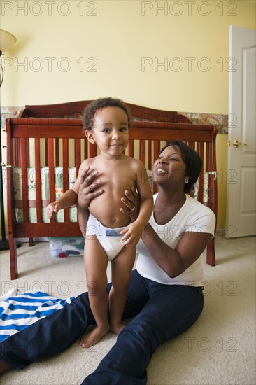 African mother playing with young son