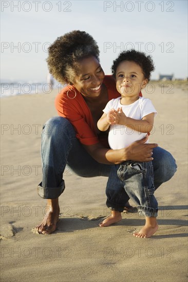 African mother on beach with son