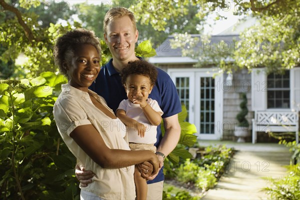 Multi-ethnic family smiling in garden