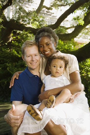 Multi-ethnic family smiling in garden