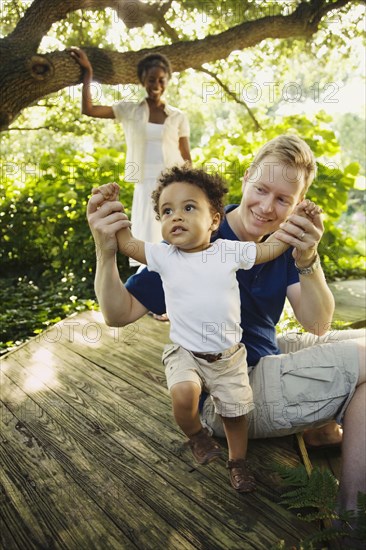 Multi-ethnic family enjoying garden