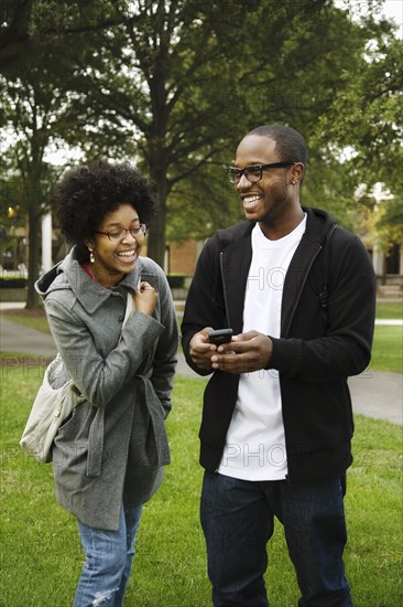 Couple with cell phone in park