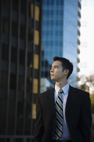 Mixed race businessman standing outdoors