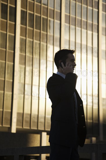 Mixed race businessman talking on cell phone