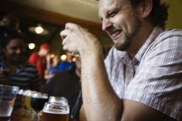 Caucasian man drinking in bar