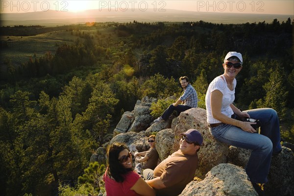 Friends resting on rocks in remote area