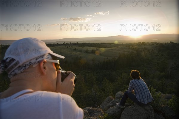 Friends resting on rocks in remote area