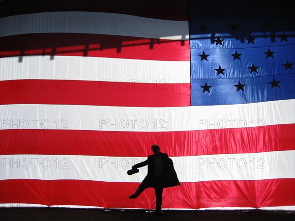 Silhouette of man behind American flag