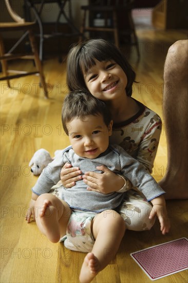 Mixed race girl holding baby brother