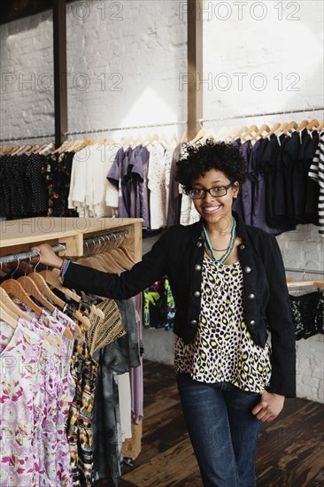 Mixed race woman working in clothing store