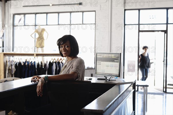 African American woman working in clothing store