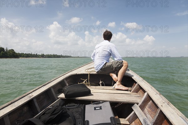 Caucasian businessman riding in boat