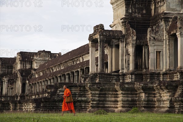 Priest walking near Angkor Wat temple