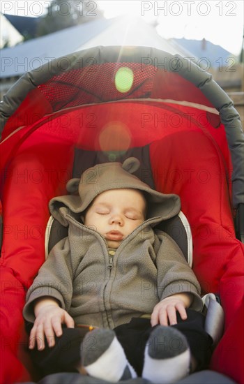 Caucasian baby sleeping in car seat