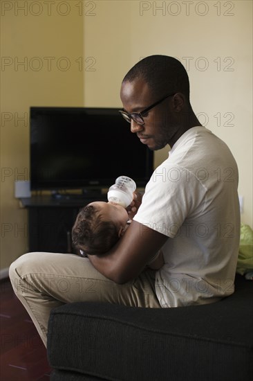 Father feeding baby