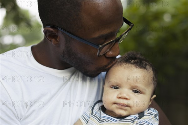 Father kissing baby