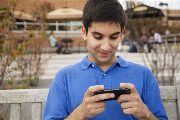 Middle Eastern student using cell phone