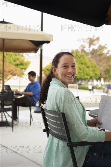 Students studying at tables on campus