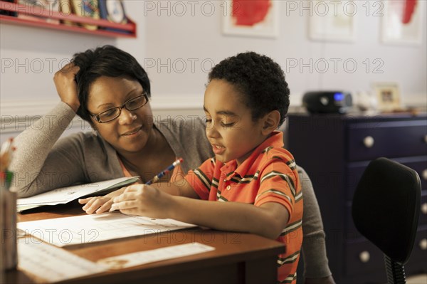 Mother helping son with homework