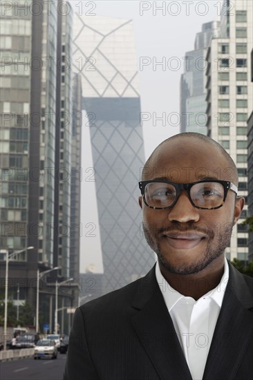 Black businessman smiling on city street