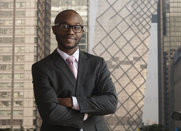 Black businessman smiling on city street