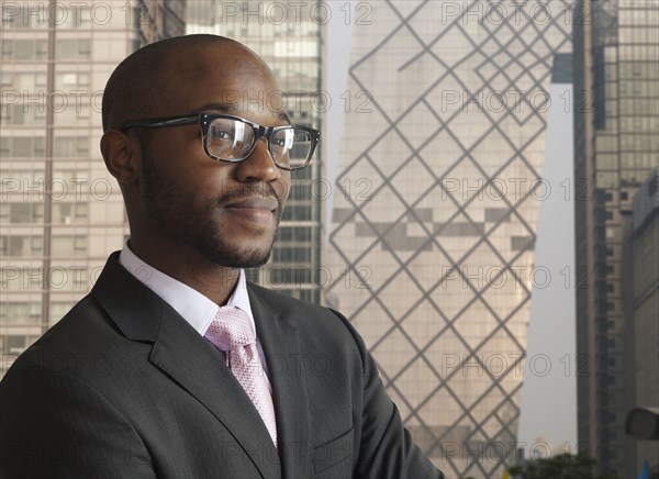 Black businessman smiling on city street