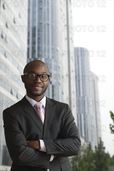 Black businessman smiling on city street