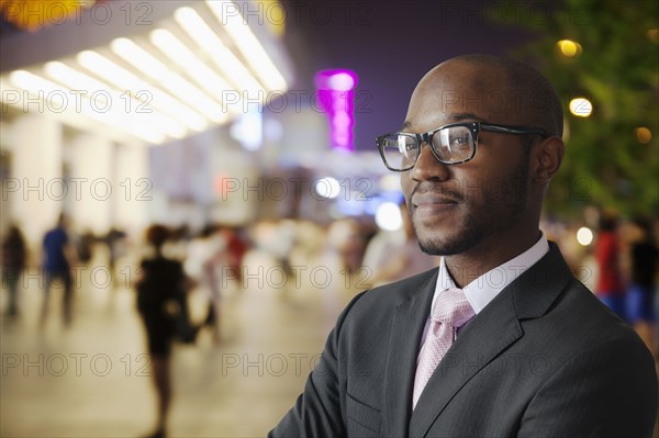 Black businessman smiling on city street