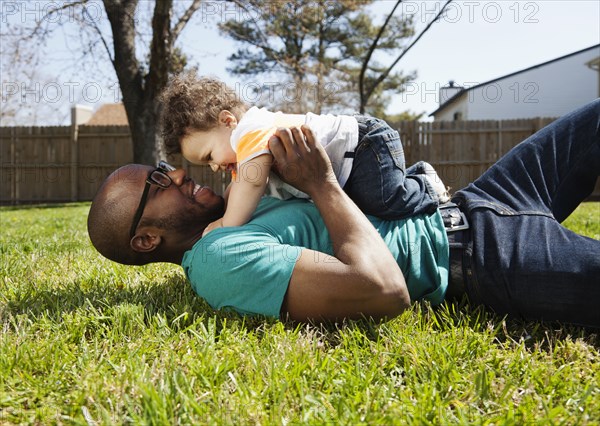 Father and baby playing in backyard