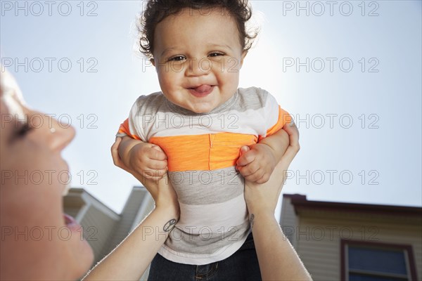 Mother and baby playing in backyard