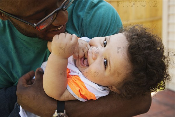 Father and baby playing outdoors