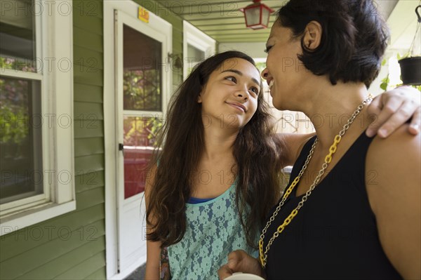 Mixed race mother and daughter hugging