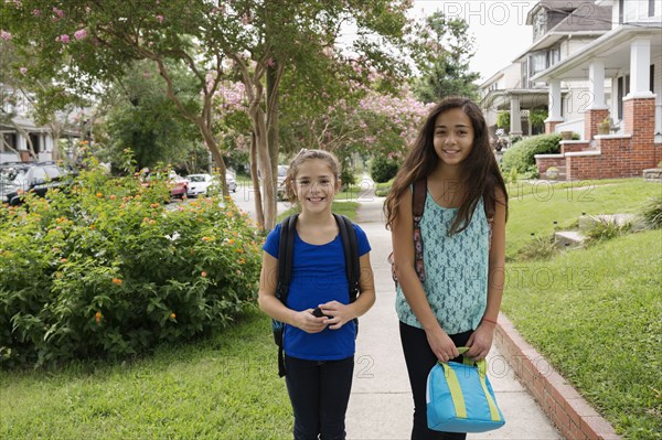 Mixed race girls walking to school