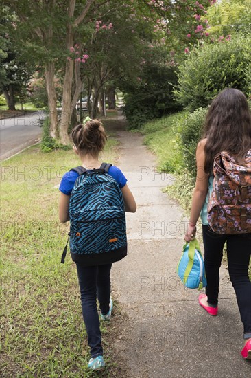 Mixed race girls walking to school