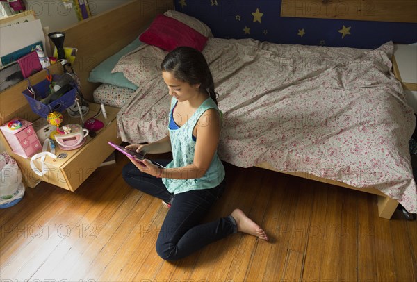 Mixed race girl using digital tablet