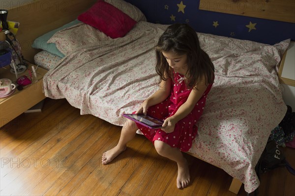 Mixed race girl using digital tablet