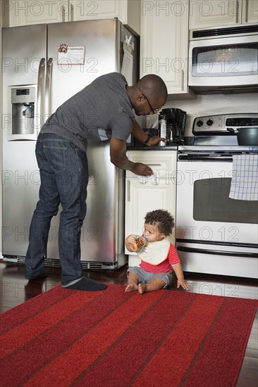 Father and toddler son in kitchen