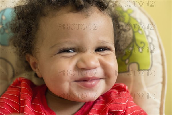 Mixed race toddler boy smiling