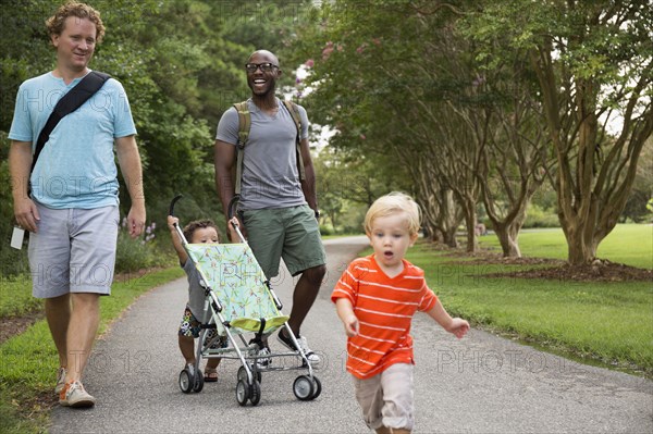 Fathers and sons walking together in park