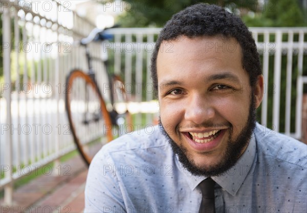 Mixed race businessman smiling outdoors