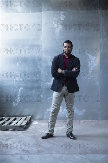 Mixed race businessman standing in warehouse