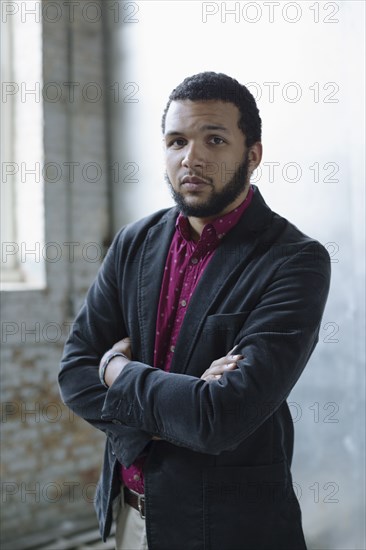 Mixed race businessman standing in warehouse