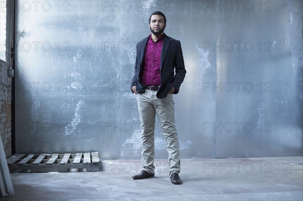 Mixed race businessman standing in warehouse
