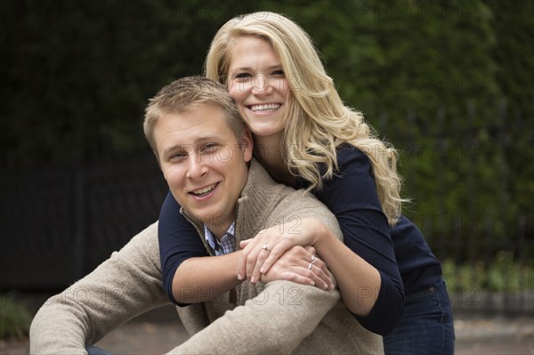 Caucasian couple hugging outdoors