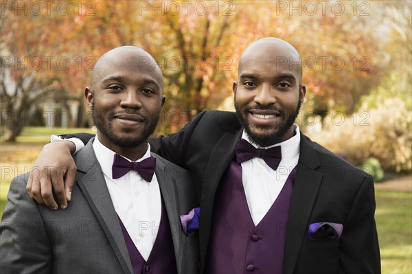 Black groom and best man posing at wedding