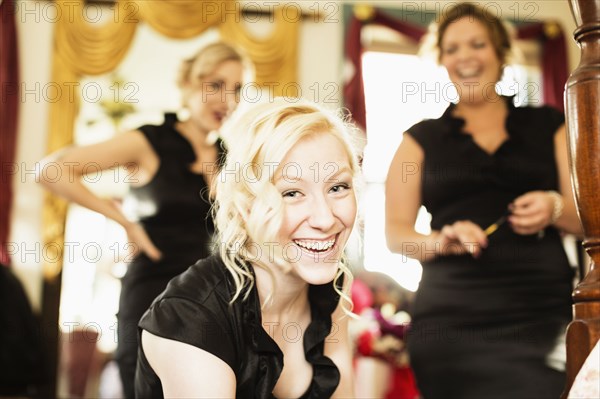 Caucasian bridesmaids smiling together