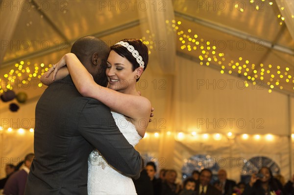 Newlywed couple dancing at reception